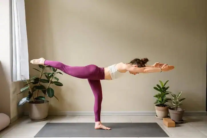 Woman doing Yoga exercise Windsor to help with toning the body. 